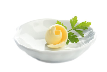 Butter curl on plate, isolated on white