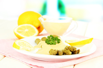 Asparagus on plate, on wooden table on bright background