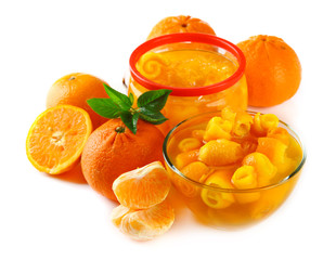 Orange jam with zest and tangerines, isolated on white