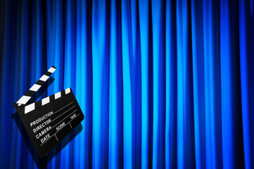 Movie clapper board against curtain