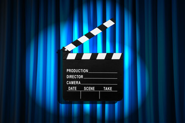 Movie clapper board against curtain