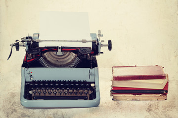 Old typewriter with books retro colors on the desk