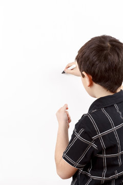 Young Boy Student In A Writing On A Whiteboard