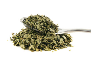 Heap of dry isolated coriander on the spoon