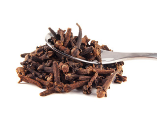 Heap dried cloves on the spoon isolated