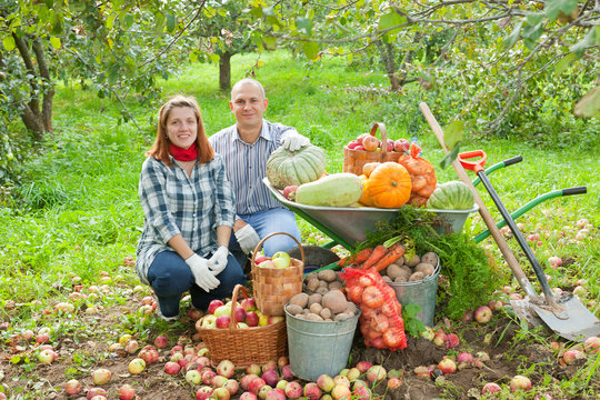 couple with  harvested vegetables