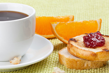 Breakfast with coffee, toast ,cherry jam and orange segment