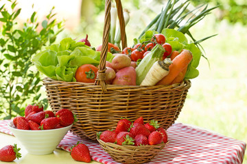 Full basket of fresh vegetables and strawberries