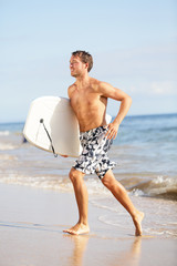Beach water sports surfing man with body surfboard