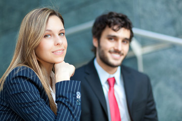 Two business people outdoor smiling 