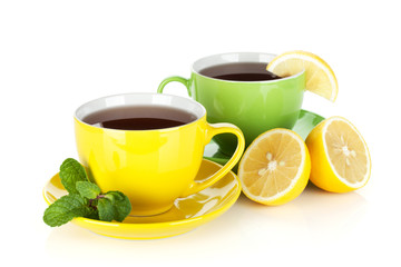 Two colorful cups of tea with lemon and mint
