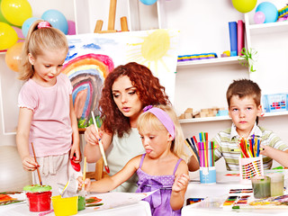 Child painting at easel.