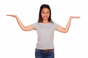 Smiling ethnic young woman holding up her palms