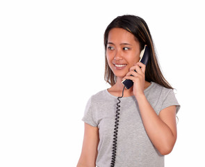 Smiling asiatic young woman speaking on phone