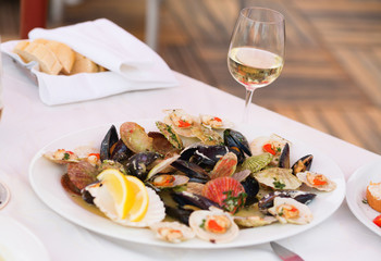 Prepared clams and glass of white wine