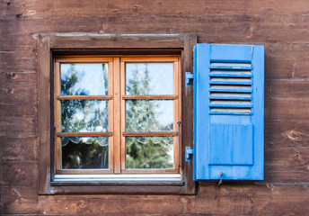 Fototapeta premium Window with Blue Door on Wooden Wall