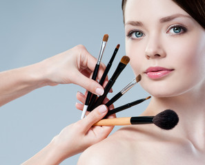 beautiful woman. Makeup brushes.