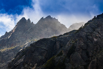 Rocky peaks and storm clouds over French Alps, in summer