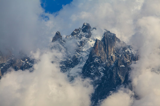 Rocky peaks and storm clouds over French Alps, in summer