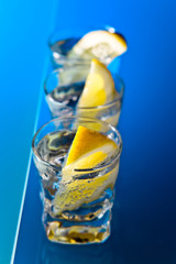 gin with lemon on a glass table