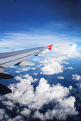 Fototapeta na wymiar Wing of the plane on sky background