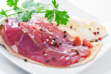 Marinated duck fillet on a white background