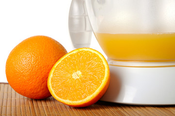 Still life with oranges and a juice extractor