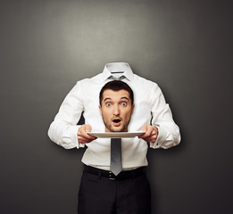 headless man holding surprised head