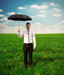 serious man holding black umbrella