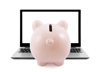 Piggy bank and laptop isolated on white