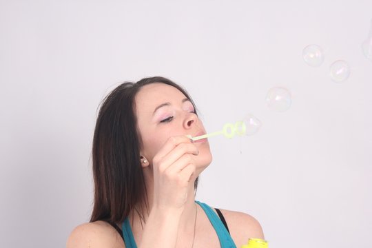 Beauty in Blue Singlet Blowing Bubbles