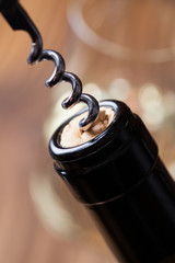 Bottle of wine with a corkscrew and glass of white wine.. - 52294081