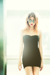 girl in sunglasses posing in elevator