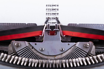 Silence written on an old typewriter .