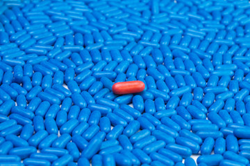 Red tablet and blue pills