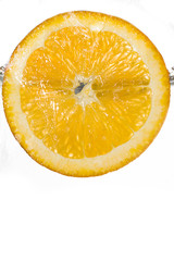 Slice orange falling into the water