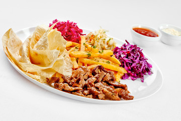 A Tasty food . Grilled meat with French fries. High quality imag