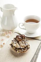 Closeup muffin with vanilla cream and hazelnuts
