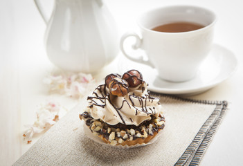 Obraz na płótnie Canvas Closeup muffin with vanilla cream and hazelnuts