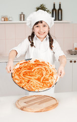 Chef girl drew a heart on the pizza