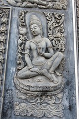 Fototapeta na wymiar Ancient old vintage buddha sculpture on the wall