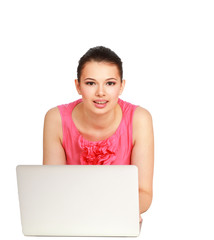 A young college girl sitting in front of a laptop