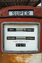 Fototapeta premium A vintage antique Gasoline fuel pump on red