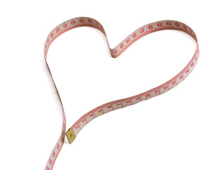 A measuring tape shaping a heart isolated on white background