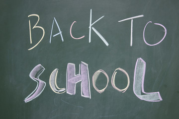 back to school title written with chalk on blackboard