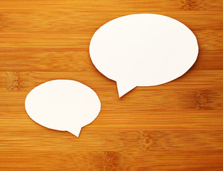 paper speech bubble on wood background