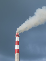 Industrial smokestack on black sky