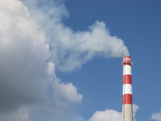 Industrial smokestack on blue sky