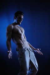 Fototapeta na wymiar Muscular Man in Blue-black degrade background