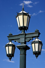 Fototapeta na wymiar old green street lamp and clouds